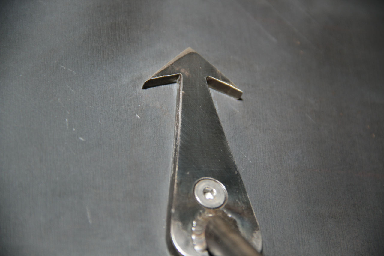 Up or north pointing metal arrow that is a part of a custom steel sign for my company: PACE (Peace. Action. Community. Equity & Expression.). Designed and made in collaboration with my friend John Jesse.