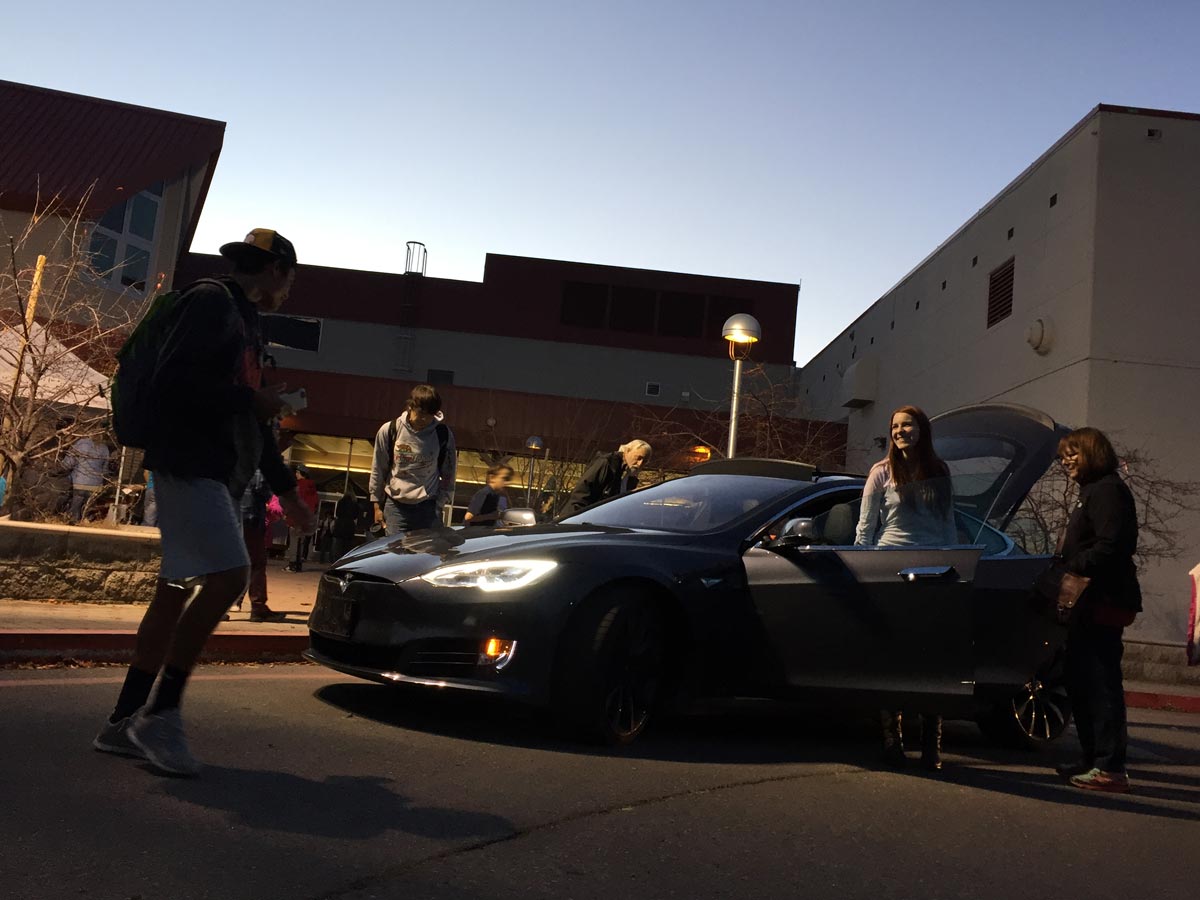 High school students around a Tesla Model S at the Truckee STEAM Fair (2016)